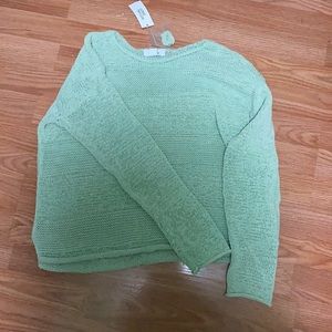 A mint green knitted sweater/pull over